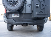 Direct rear view of a Mercedes Sprinter van featuring the ROAMBUILT Rear Bumper, showcasing the full replacement aluminum bumper with integrated step, dual light pockets, and compatibility with parking sensors, blind spot assist, and OEM receiver hitch—designed for durability, utility, and off-road performance.