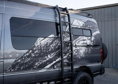 profile view of the full ROAMBUILT Flatpack Ladder mounted on a Mercedes Sprinter, highlighting slim, low-profile design and full ladder height.