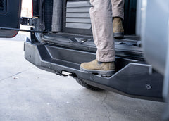Close-up shot of the rear step on the ROAMBUILT Rear Bumper for the Mercedes Sprinter van, highlighting the sturdy aluminum construction, textured black powder coat finish, and integrated design for easy access to the rear cargo area.