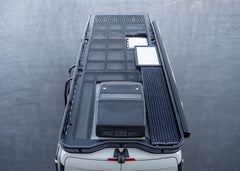 Overhead view from the rear showing the entire ROAMBUILT Safari 2.0 roof rack with curved front, perforated decking, and modular 3- or 4-piece design for 2007+ Sprinter vans.