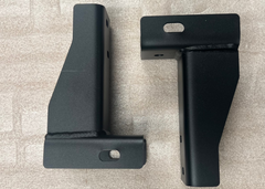Top-side angled view of a pair of ROAMBUILT replacement frame brackets for 2019+ Mercedes Sprinter 2WD and 3500 dually models, showing custom-fabricated steel construction and mounting points.