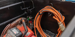 @expanded Orange extension cord coiled, hanging on a Tool Hook inside the Tool Box.