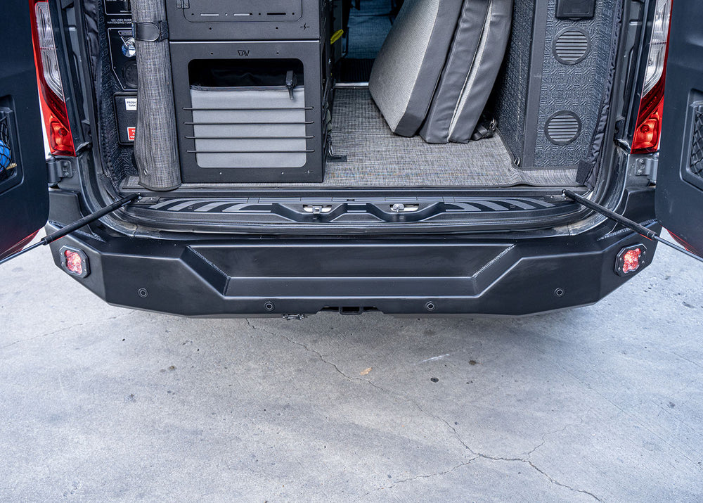 Top-down view of the ROAMBUILT Rear Bumper on a Mercedes Sprinter van, highlighting the built-in step and its alignment with the rear cargo area for easy access, with durable aluminum construction and textured surface for secure footing.