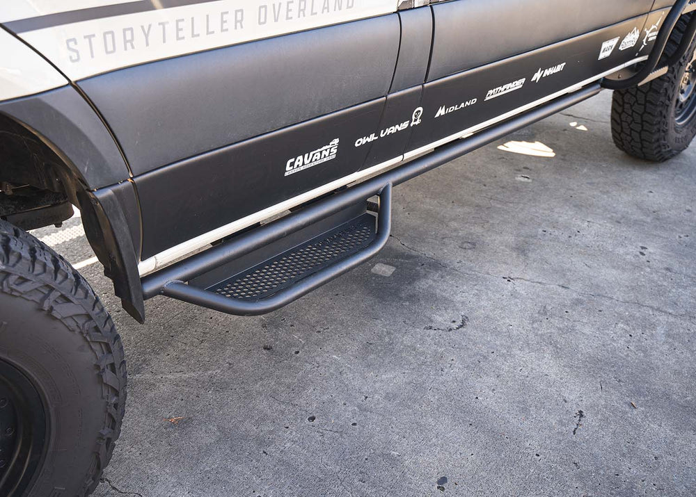 Overhead view from front to back of the ROAMBUILT Mercedes Sprinter Side Step with ladder installed, showing full step length, perforated decking, and seamless integration with side ladder.