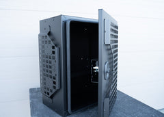Door of ROAMBUILT Universal Aluminum Storage Box half open, revealing both sides of the black lockable compression latch, exterior molle panels, and the water-resistant gasket lining.