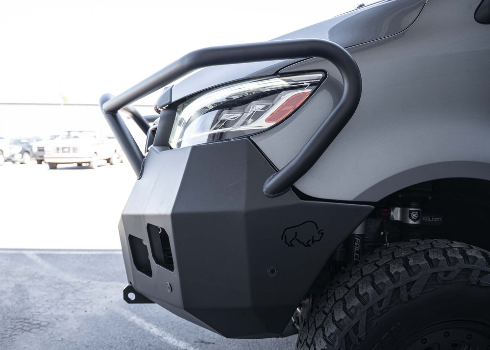 Driver-side view of a Mercedes Sprinter van equipped with the Full Guard Front Bumper, highlighting its lightweight hybrid steel and aluminum construction, seamless body integration, and rugged design for enhanced off-road protection.