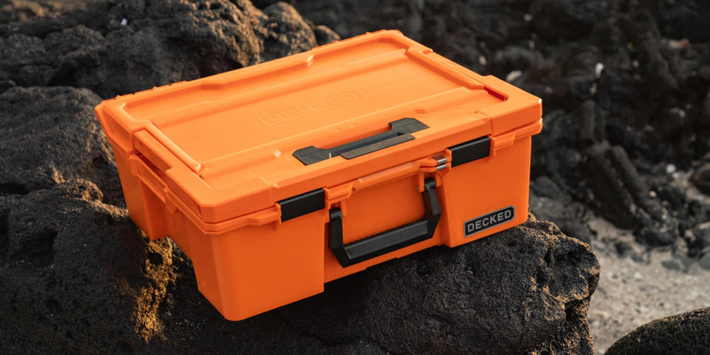 [A0020-HRAK-ORG] @expanded The Blaze Orange Halfrack sitting on lava rock, the black and orange are a stark contrast.