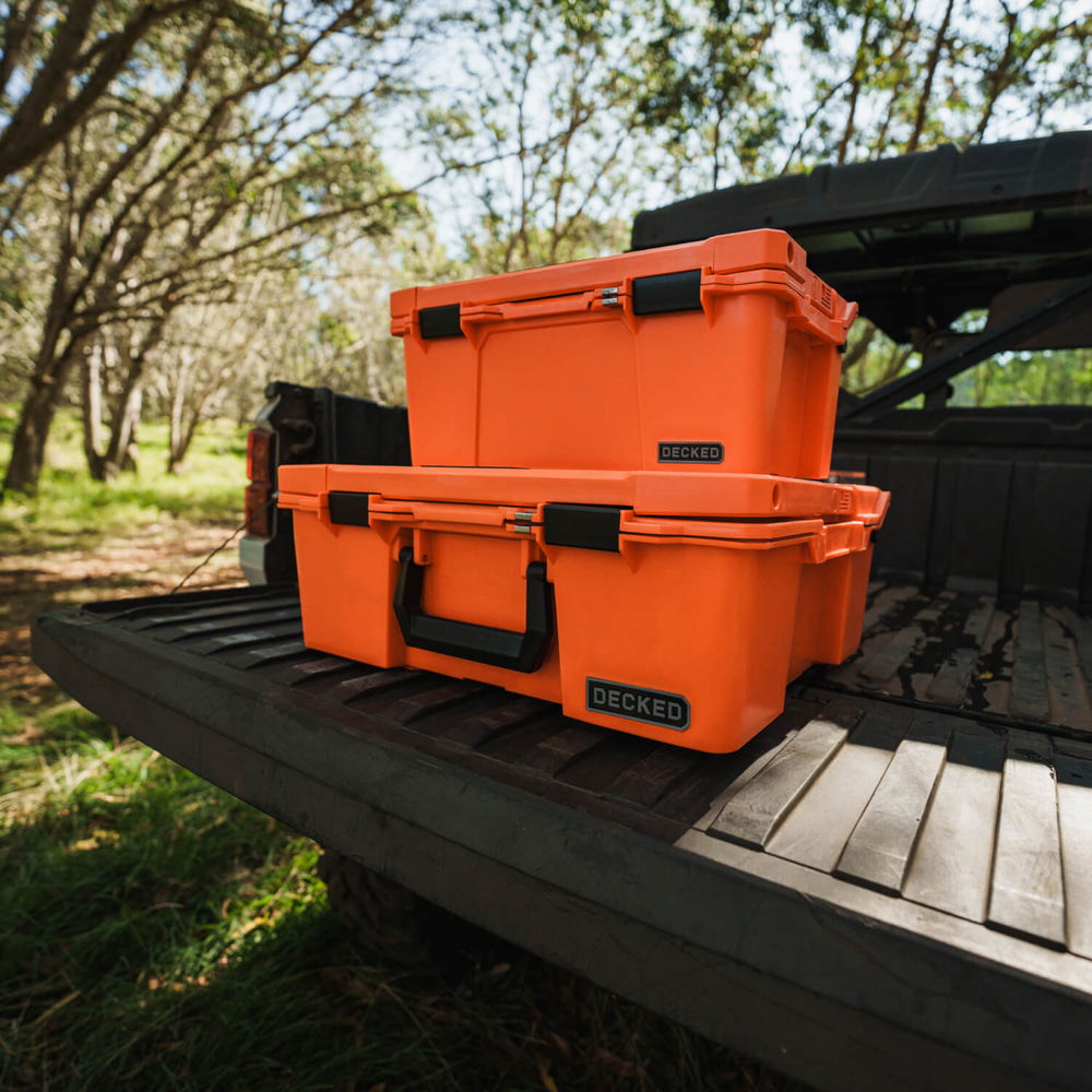 [A0020-HRAK-ORG] The Blaze Orange Sixer and Halfrack stacked on each other on the tailgate of a side-by-side.