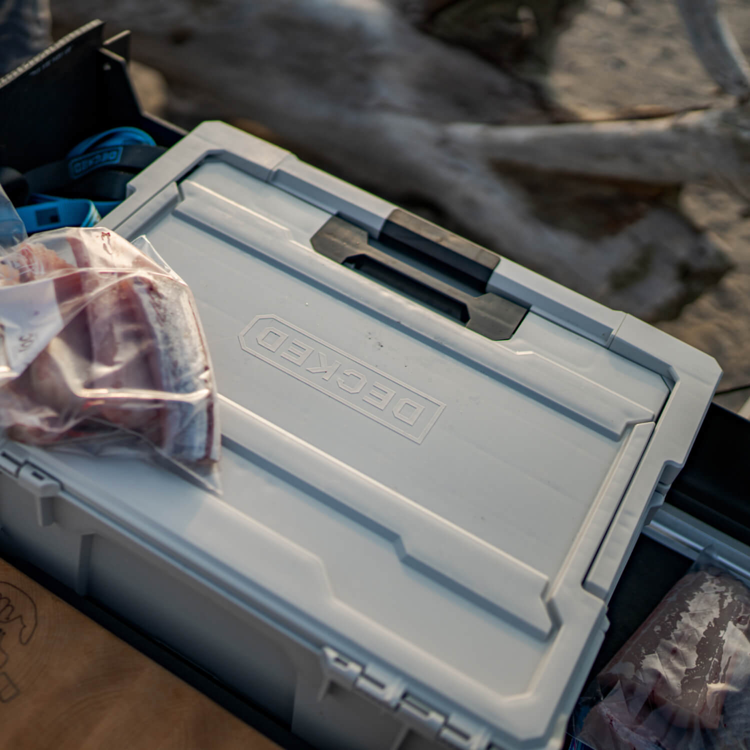 [A0020-HRAK-GRY] The Cool Gray Halfrack inside of a midsize Drawer System, nearby are newly packaged fish fillets from a day on the water.