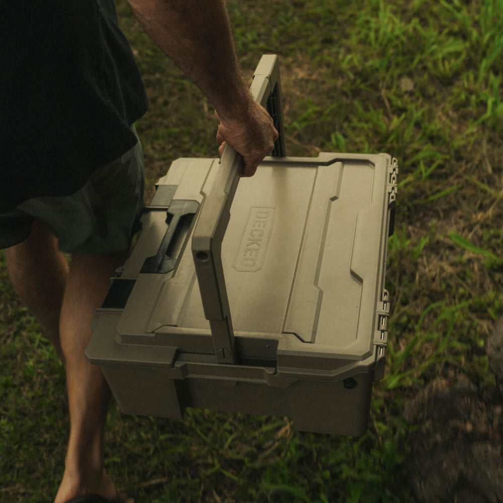 [A0020-HRAK-TAN] A man carrying the Desert Tan Halfrack by the handle.