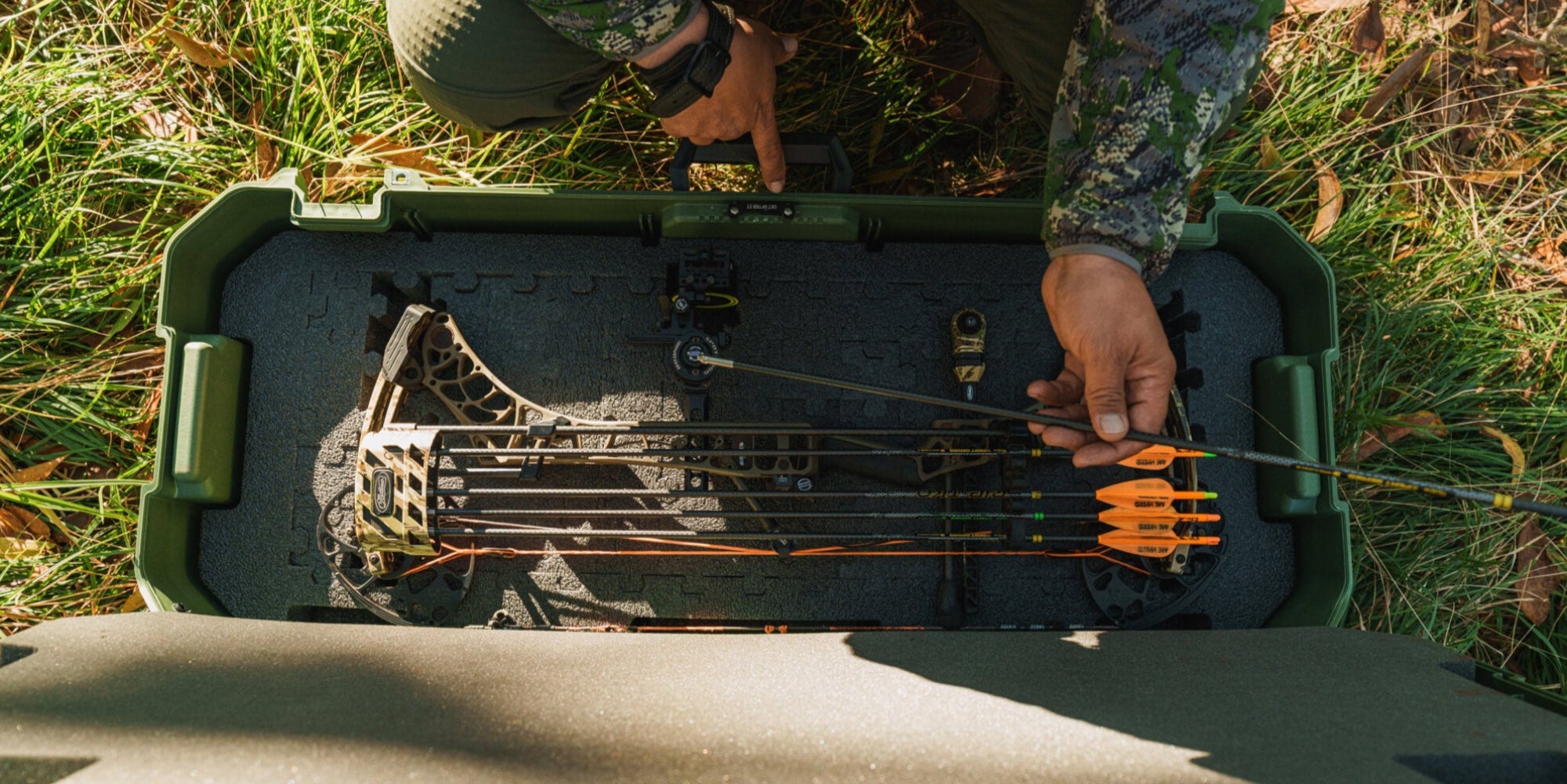 [A0031-MANF-GRN] @expanded A top view of an open Ranger Green Honcho 80 with a compound bow and arrows stored neatly inside using the Honcho PuzzleFoam.