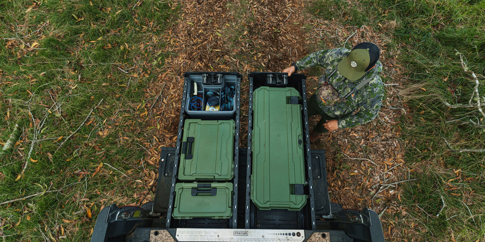 [A0030-MMAN-GRN] @expanded A man in camo admiring how organized his DECKED Drawer System is due to his collection of Ranger Green D-co Cases.