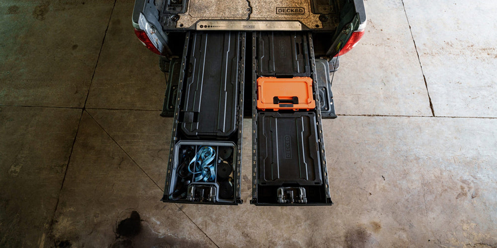 [A0010-SIXR-ORG] @expanded A bird's eye view of an open full-size Drawer System with three black D-co cases surrounding a Blaze Orange Sixer, the orange case pops against the surrounding black cases.