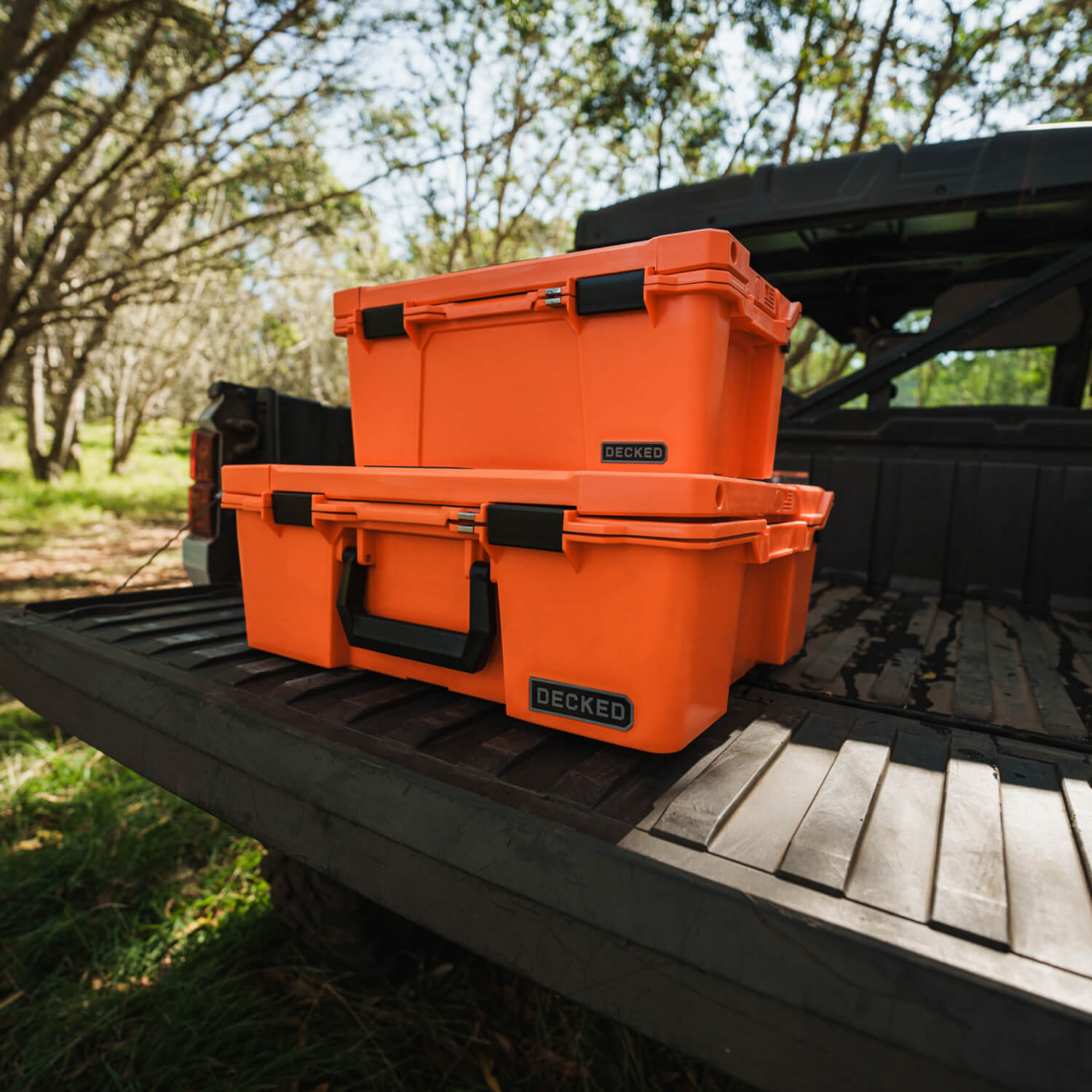 [A0010-SIXR-ORG] The Blaze Orange Halfrack and Sixer stacked on the tailgate of a side-by-side.