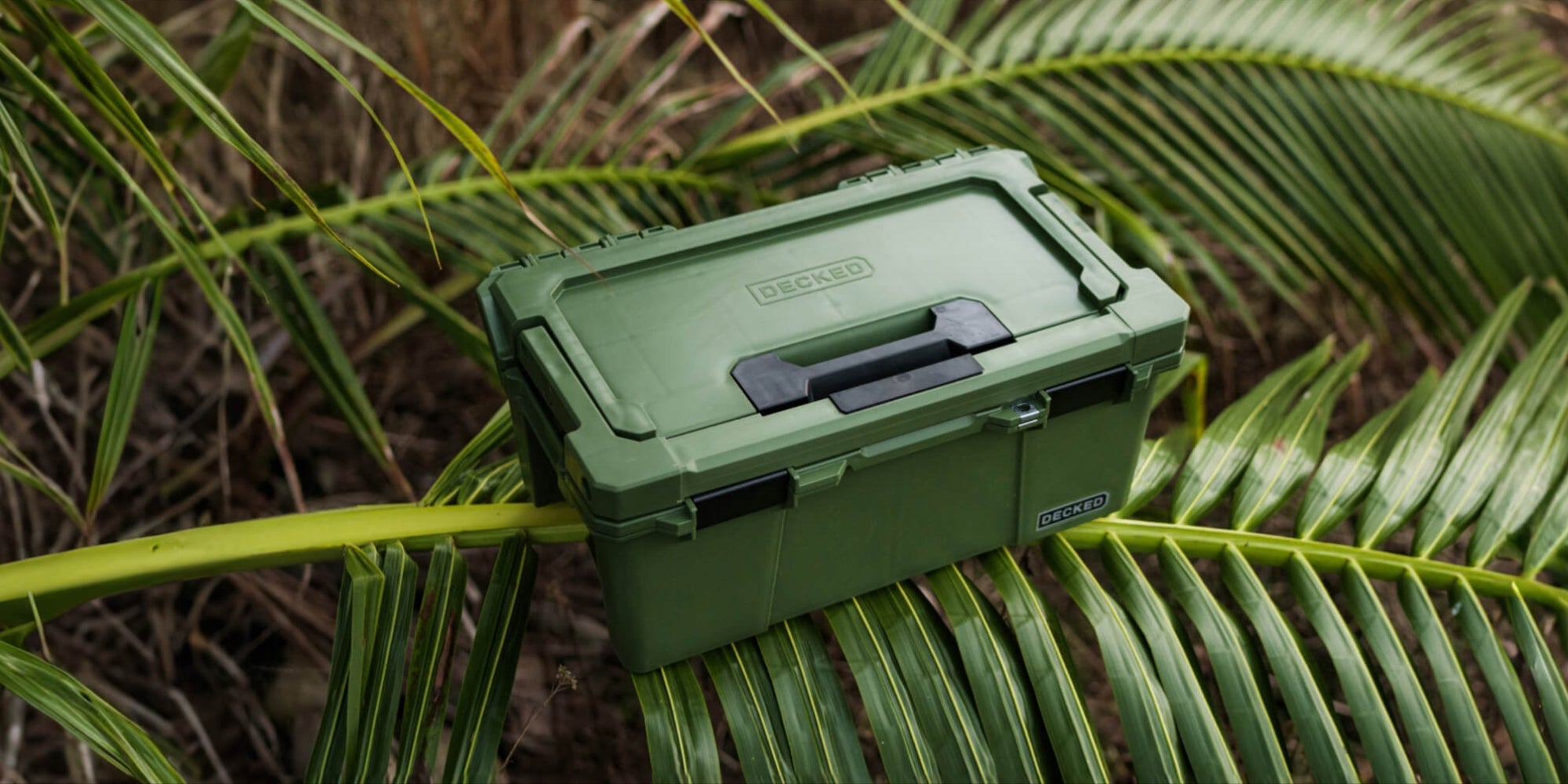 [A0010-SIXR-GRN] @expanded The Ranger Green Sixer sitting on top of a palm frond, the image screams Ranger Green.