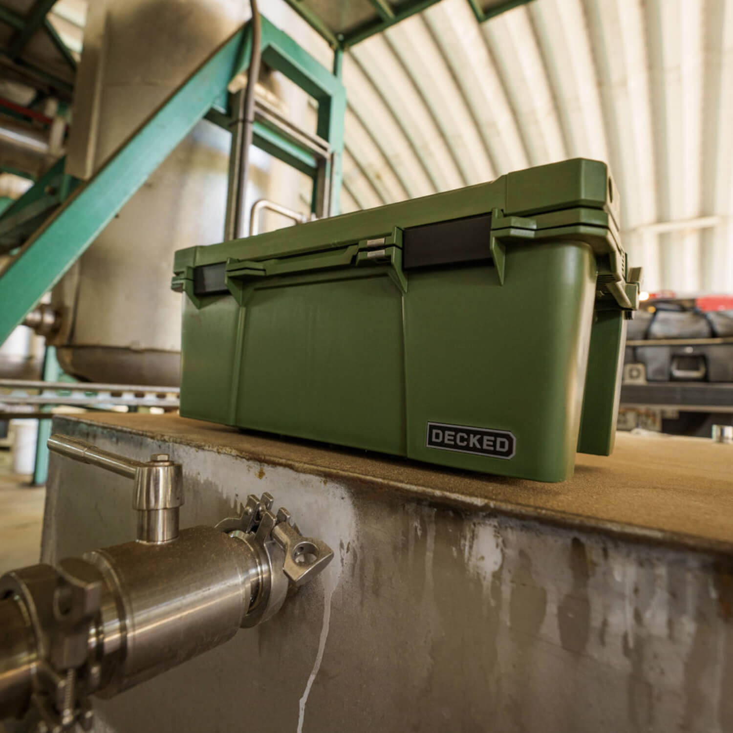 [A0010-SIXR-GRN] The Ranger Green Sixer in a garage, acting as the perfect storage case for tools, fishing gear, or camping supplies.