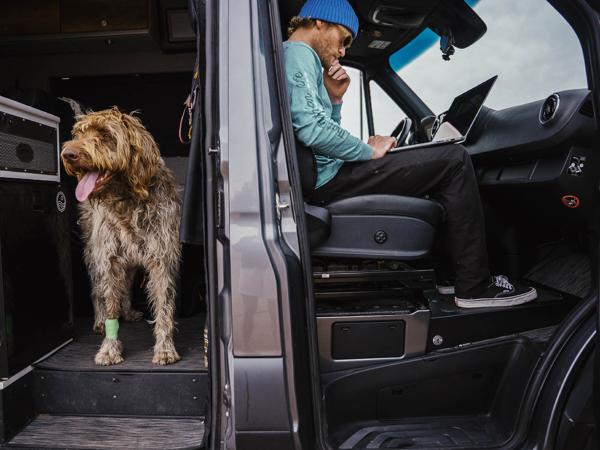 Person using passenger foot riser in Sprinter camper van