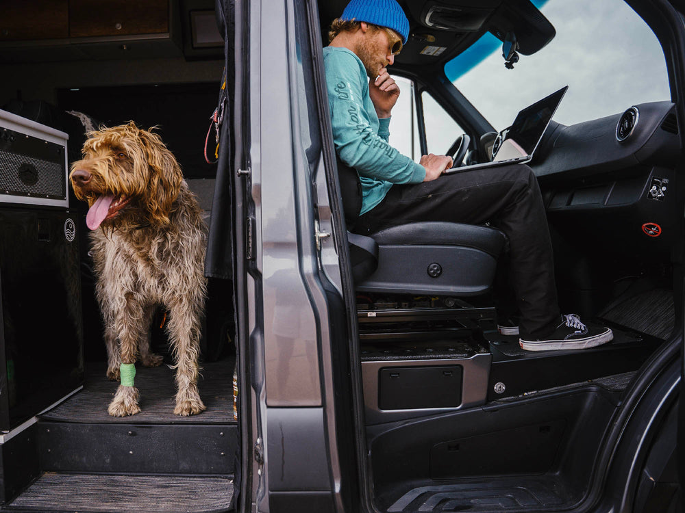 Person using passenger foot riser in Sprinter camper van