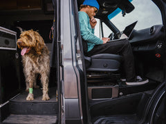 Person using passenger foot riser in Sprinter camper van