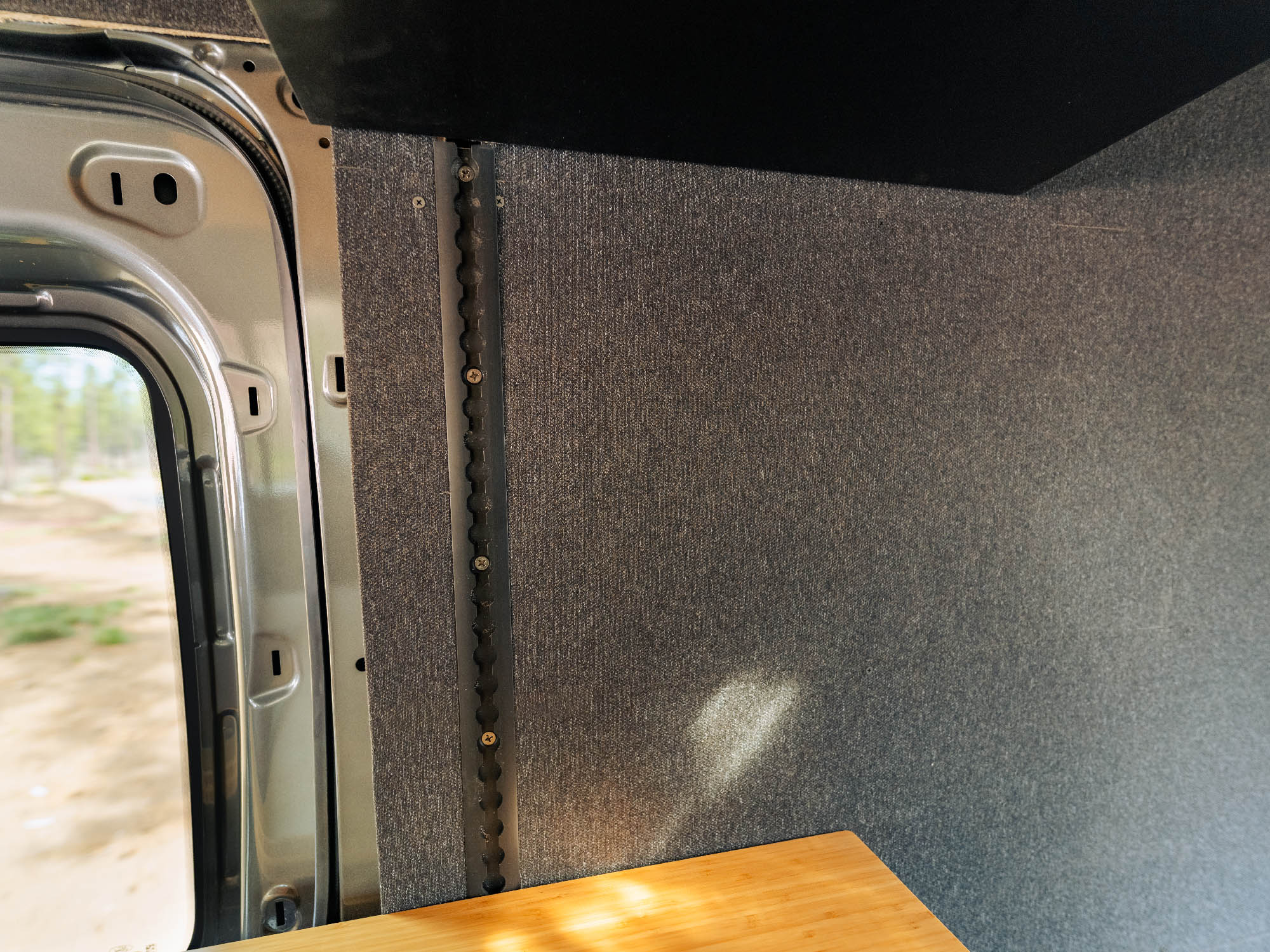 Small section of the Transit Bed Bracket Flush Mount L-Track cut to fit custom area in van