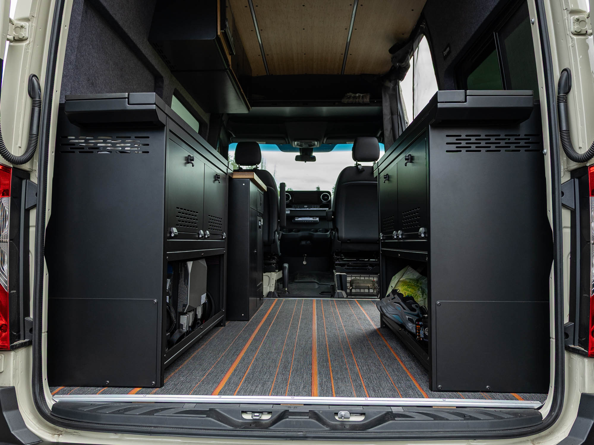 View of installed Modular Cabinet Bed System for Sprinter & Transit in North-South orientation from the back of the van 