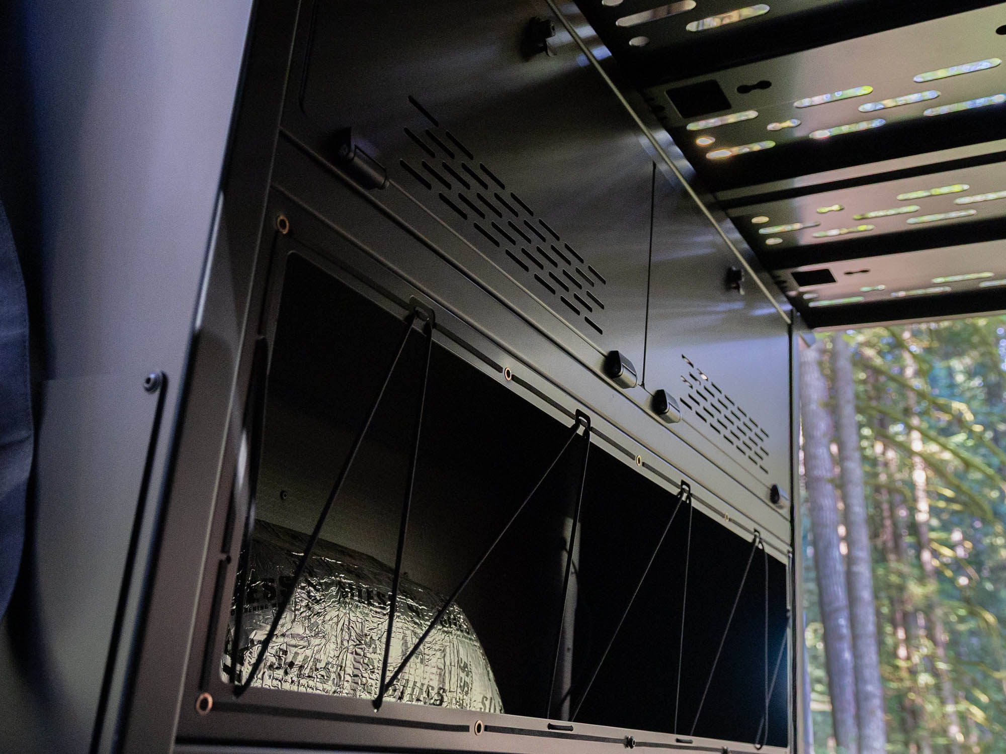 Installed Modular Cabinet Bed System for Sprinter & Transit with bungee system in use