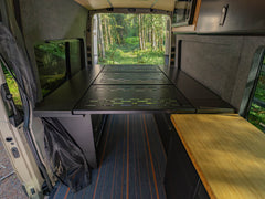 Modular Cabinet Bed System for Sprinter & Transit in North-South orientation installed in adventure van camping in the woods