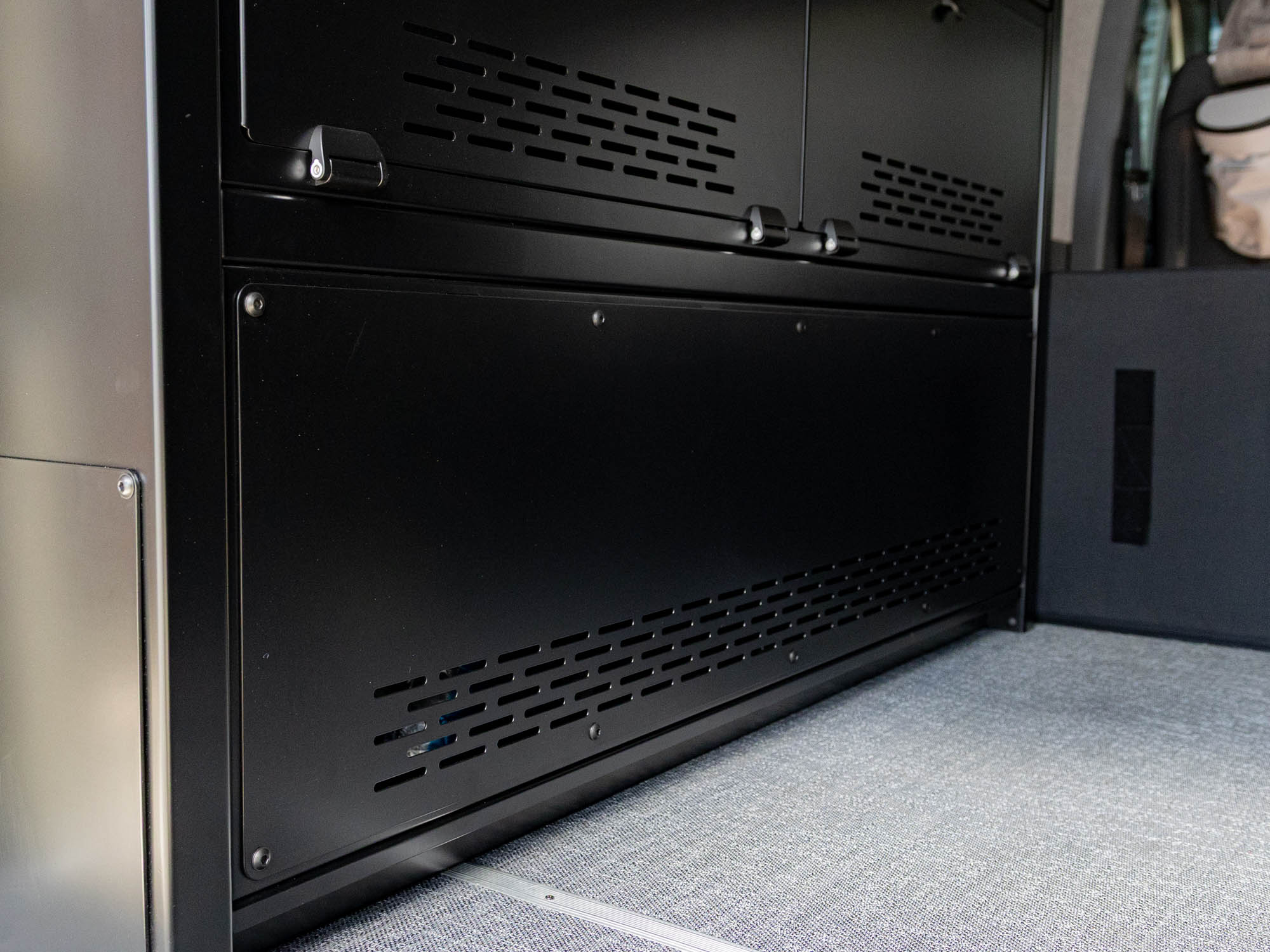 Large fixed panel for power and water systems in the Modular Cabinet Bed System for Sprinter & Transit 