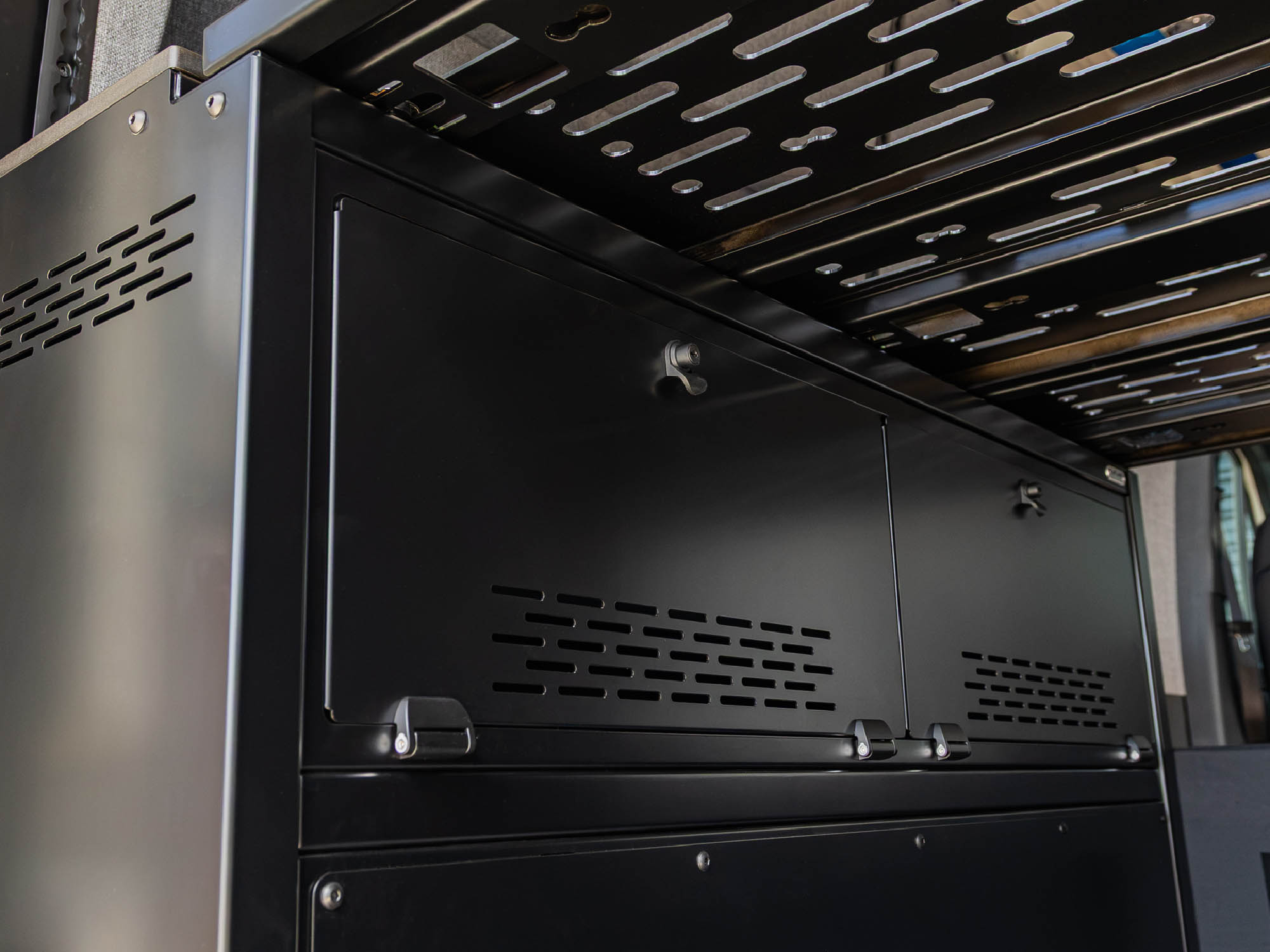 Easy-open storage doors on the Modular Cabinet Bed System for Sprinter & Transit 