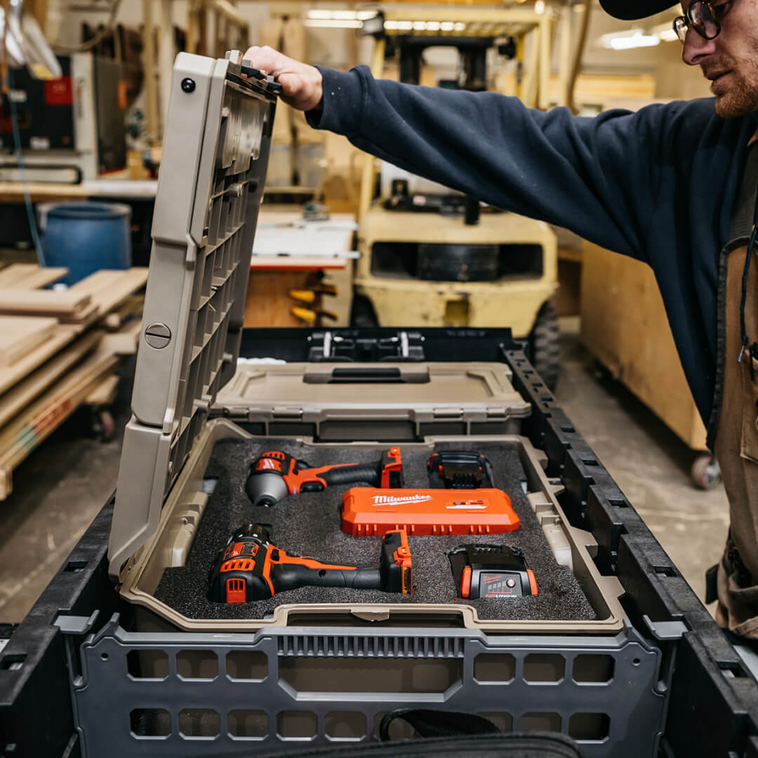 [A0021-HRFM-BLK] Man opening a Halfrack 32 with power tools organized inside the custom foam