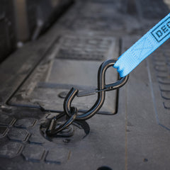 [A0087-RING-BLK] Closeup of Blue ratchet strap hooked on a D-ring Tie Down