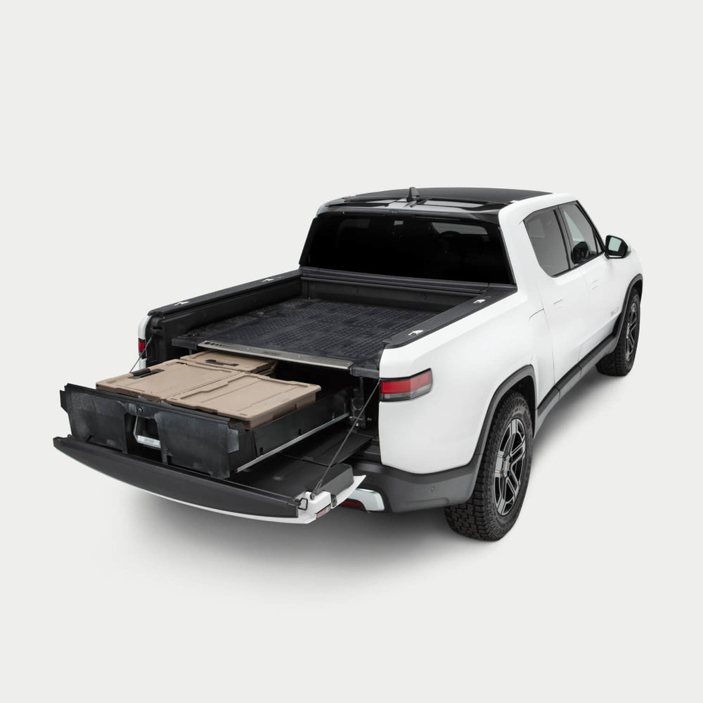 [YV1] Side angle view of a Drawer System installed in a Rivian R1T with the drawer open and one Sixer, a Halfrack, and a Payloader D-co case inside.
