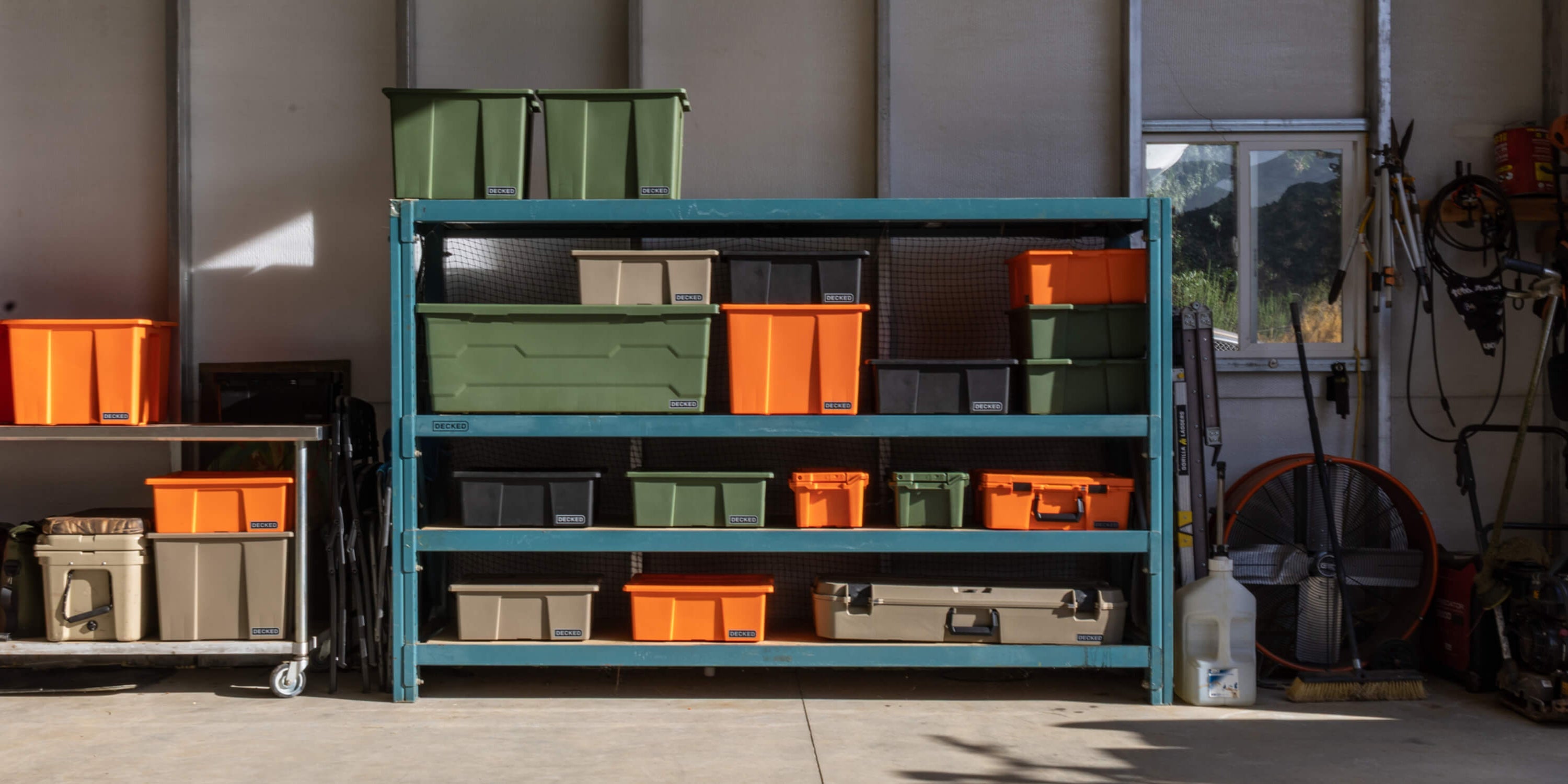[A0040-DBIN-XXX] @expanded Storage rack with green, orange, black and tan DECKED Payloader Bins in a large garage.