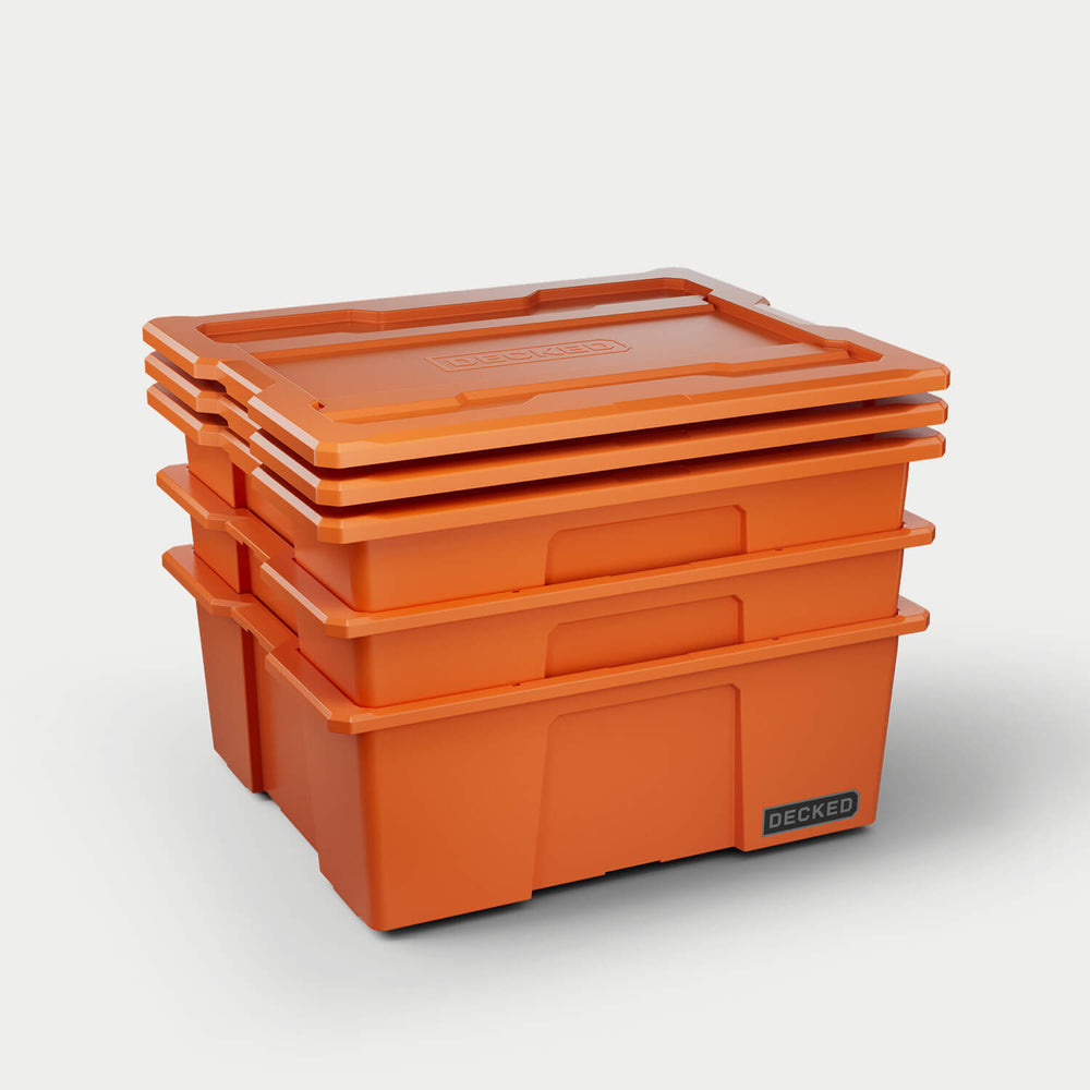 [A0040-DBIN-ORG] Three blaze orange Payloader bins nested together with the three lids stacked on top. 