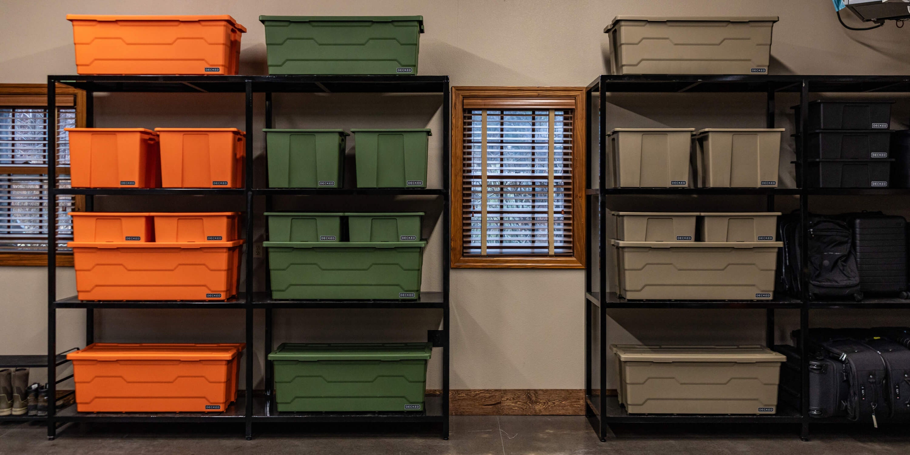[A0040-DBIN-XXX, A0040-DBIN-GRN] @expanded Storage shelves in a garage filled with various sizes of DECKED Payloader Bins, organized by color.