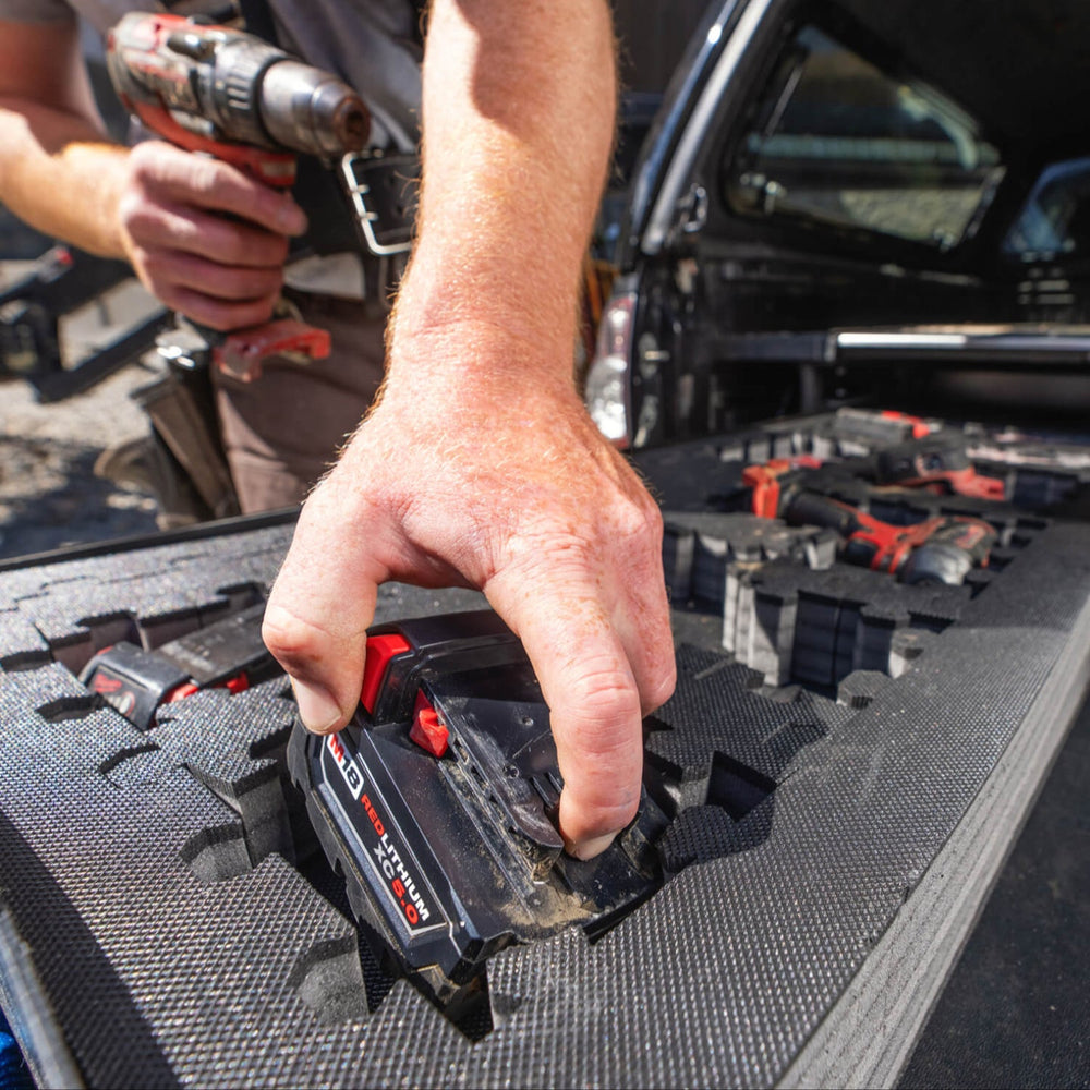 [A0152-PZFM-VYLG, A0153-PZFM-VYST] A close up of power tools organized into compartments in the Piecekeeper PuzzleFoam.