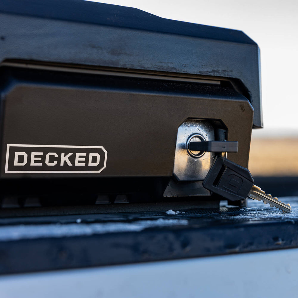 [DTB2-BLK, DTB2-TAN, DTB2T22-BLK, DTB2T22-TAN] Key inserted into the DECKED Tool Box lock on the driver side of a truck bed.
