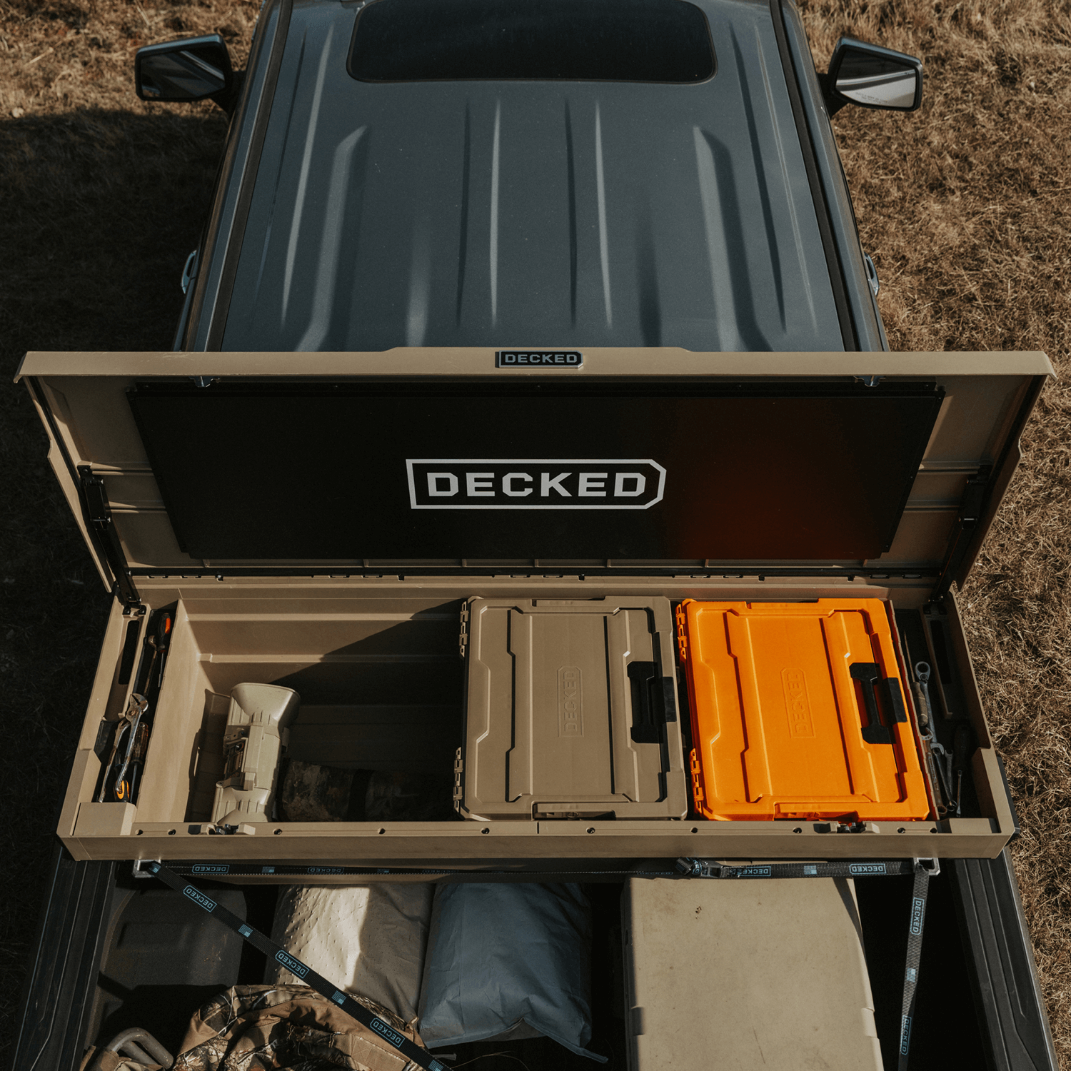 [DTB2-TAN, DTB2T22-TAN] Open truck bed with 'DECKED' Tool Box storage system and various items inside.