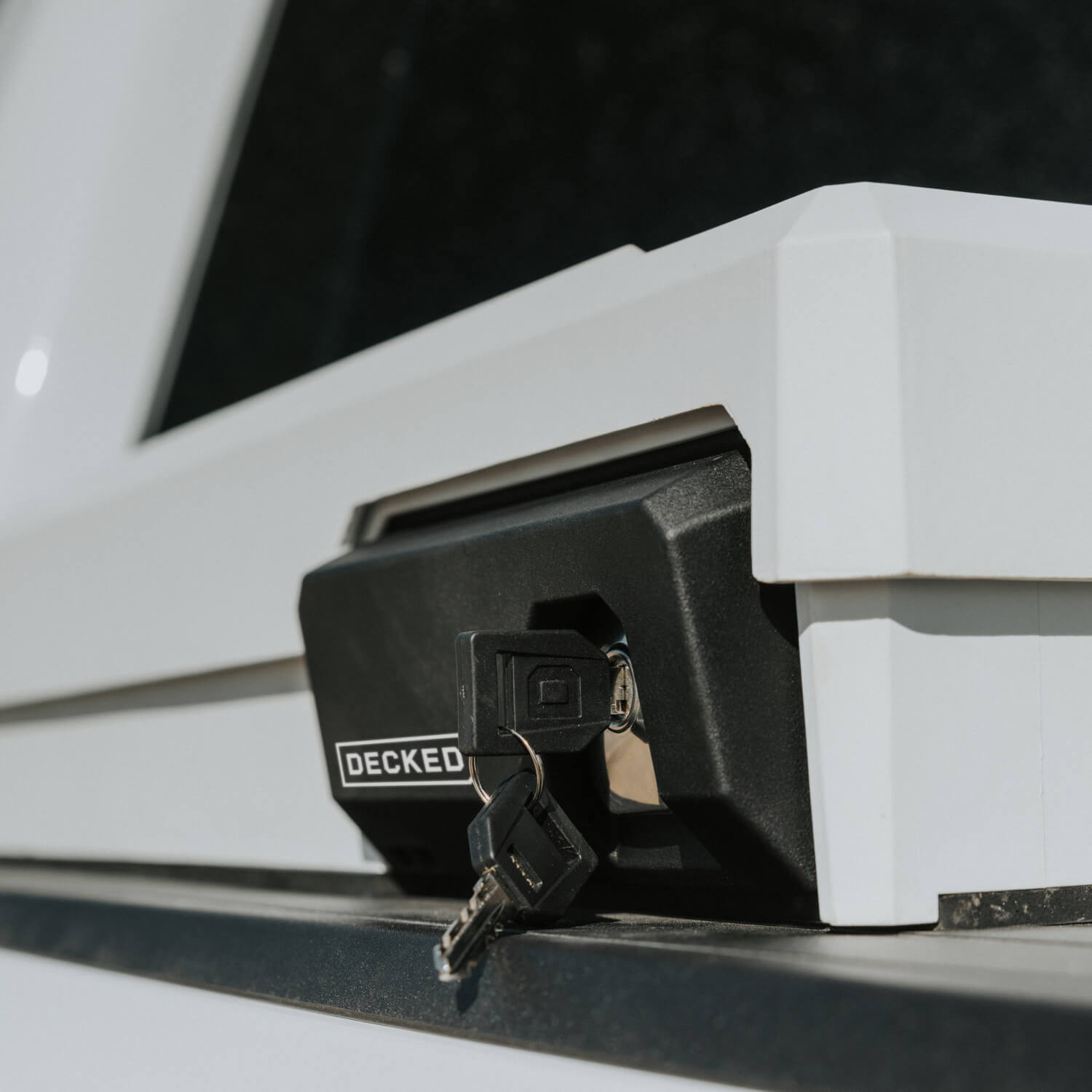 [DTB2-WHT, DTB2T22-WHT] Close-up of a key inserted into a vehicle's DECKED Tool Box lock.