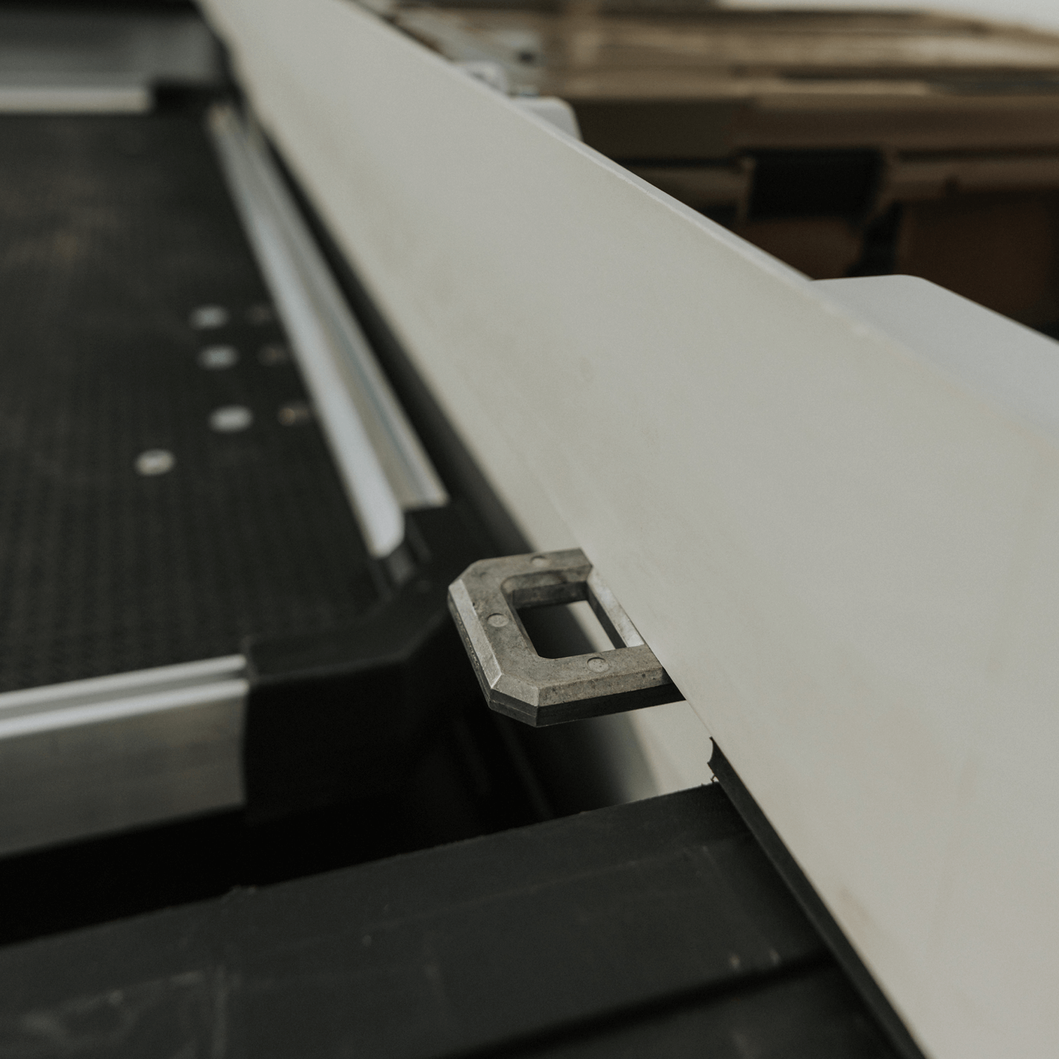 [DTB2-WHT, DTB2T22-WHT] Metal D-ring Tie Down bracket mounted on a white Tool Box with a blurred background