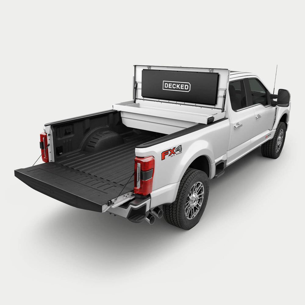 [google-white-tool-box] White pickup truck with an white DECKED Tool Box open in the bed.