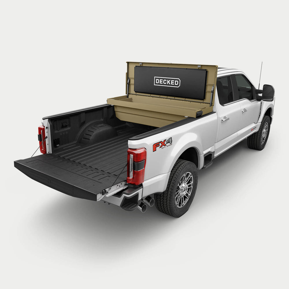 [google-fender-dirt-tool-box] White pickup truck with a tan DECKED Tool Box open in the bed.